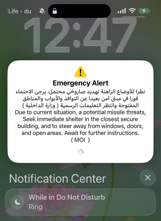 A missile threat emergency alert in Arabic and English advises seeking immediate shelter away from windows, doors, and open areas, and awaiting further instructions.